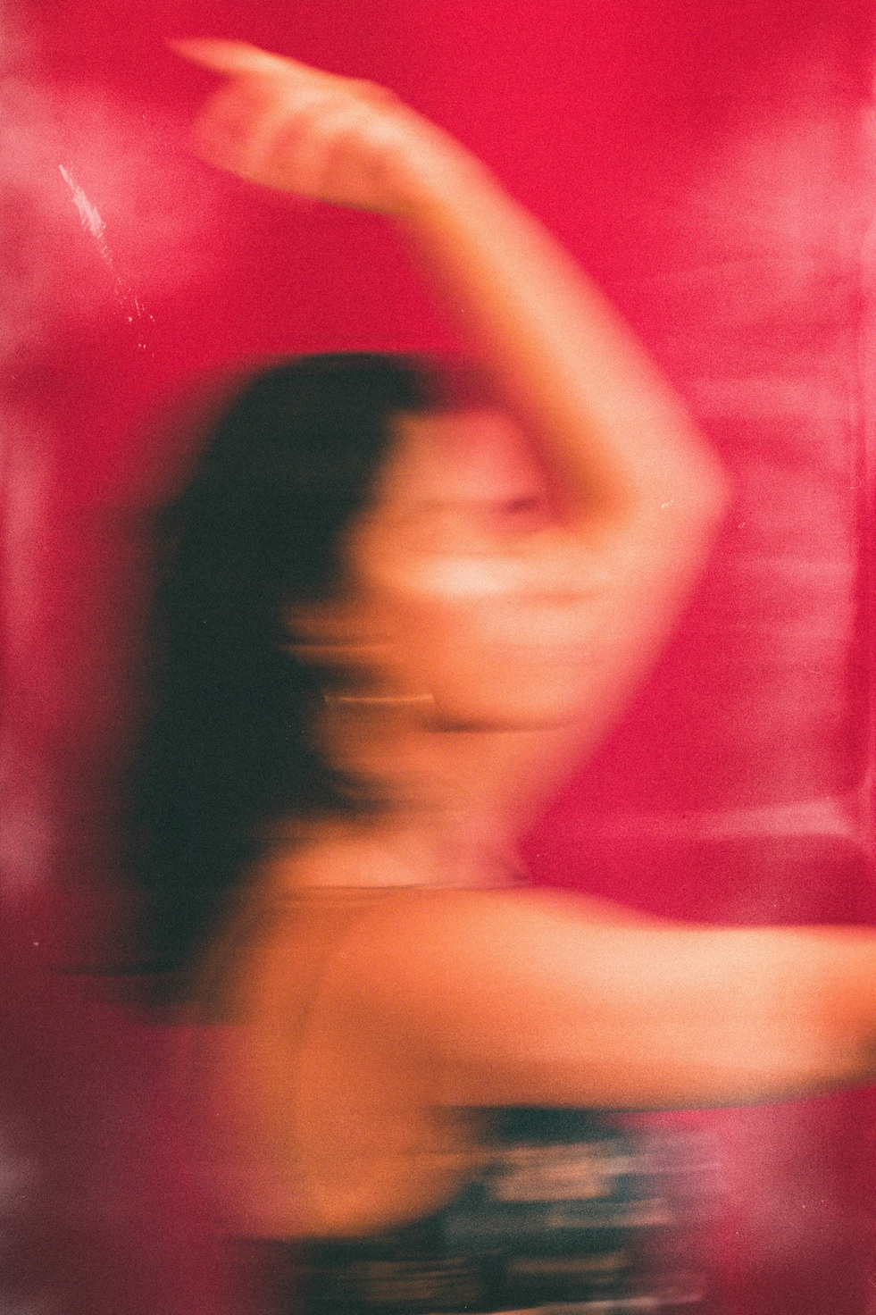 Perry study — a figure blurred in motion, one arm raised, in the red room